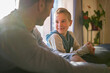 © Louis-Paul Photo - father and son sit on the sofa at home
