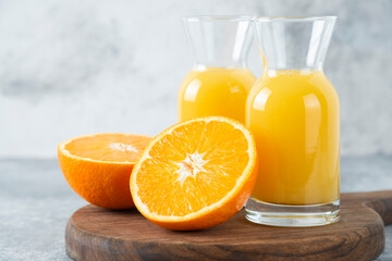 Wall Mural - Glass pitchers of juice with slice of orange fruit