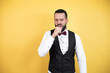 © Irene - Young man with beard wearing bow tie and vest coughing