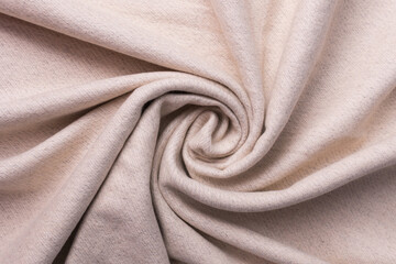 The fabric is in a beige color, twisted in a spiral. Top view