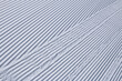 © Alexandra Scotcher - Straight diagonal lines in white winter snow on groomed piste surface