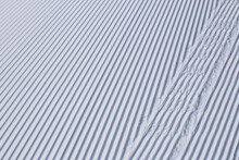 Close Up Of Straight Lines In Freshly Groomed Clean, White Snow At A Ski Resort