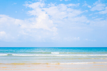 Beautiful clean beach in south of Thailand, and small wave from blue sea under clear blue sky in a sunny day