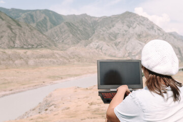 Wall Mural - woman with laptop in the mountains	
