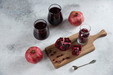 Two cups of pomegranate juice on a marble background