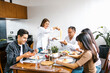 © Marcos - latin family eating pasta together in home in Mexico city