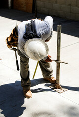 Wall Mural - Construction worker adjusting a steel support leg