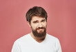 © SHOTPRIME STUDIO - Sad man on pink background cropped view of white t-shirt and bushy beard