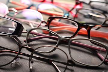 Wall Mural - Different multi-colored eyeglass frames close-up on gray background.