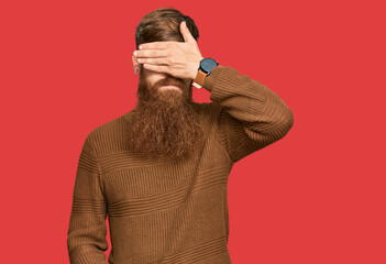 Wall Mural - Young irish redhead man wearing casual clothes and glasses covering eyes with hand, looking serious and sad. sightless, hiding and rejection concept