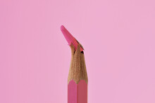 Close-up Of Broken Tip Of Pink Colored Pencil On Pink Background - Concept Of Violence Against Women