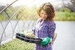 © Stocked House Studio - happy female workers trimming plants in greenhouse