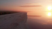 Aerial Drone View To Misty Salt Mineral Lake With Pink Water And Coastline
