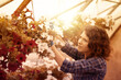 © Stocked House Studio - happy female workers trimming plants in greenhouse