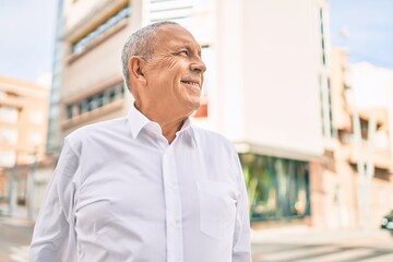 Wall Mural - senior man smiling happy walking at the city.