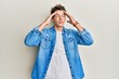 © Krakenimages.com - Handsome caucasian man wearing casual denim jacket with hand on head, headache because stress. suffering migraine.