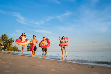  Holiday summer party with friends on the beach .Group of family and friends  jumping on the beach. lifestyle people vacation holiday on beach