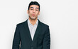 © Krakenimages.com - Handsome hispanic man wearing business clothes looking at the camera blowing a kiss on air being lovely and sexy. love expression.