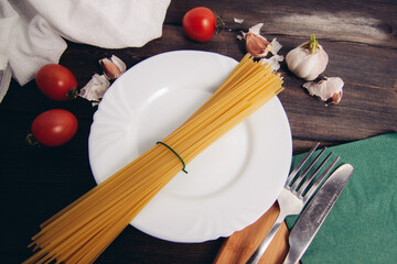 ingredients for making italian pasta plate with kitchen utensils