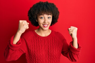 Young hispanic girl wearing casual clothes screaming proud, celebrating victory and success very excited with raised arms