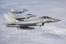 RAF Typhoon Fighter Jets. Supersonic Interceptors  Flying In Formation High Above The Clouds