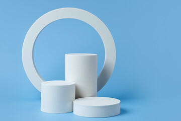 Wall Mural - white podium to show cosmetic products with geometric forms on blue background. background for brand