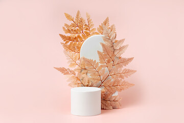 Wall Mural - White podium with branch of leaves and arch to show cosmetic products. Beige color background for branding and packaging presentation.