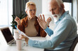 © Goran - Frustrated senior couple arguing about their home finances at home