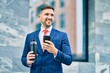 © Krakenimages.com - Young caucasian businessman smiling happy using smartphone at the city.