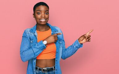 Poster - Young african american woman wearing casual clothes pointing aside worried and nervous with both hands, concerned and surprised expression