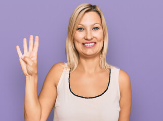 Middle age caucasian woman wearing casual clothes showing and pointing up with fingers number four while smiling confident and happy.