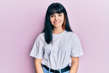 Young hispanic girl wearing casual clothes with a happy and cool smile on face. lucky person.