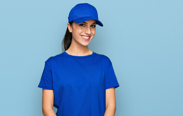 Young hispanic girl wearing delivery courier uniform with a happy and cool smile on face. lucky person.