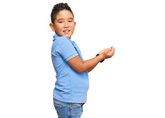 Sticker - Little boy hispanic kid wearing casual clothes pointing aside with hands open palms showing copy space, presenting advertisement smiling excited happy