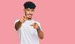© Krakenimages.com - Young arab man wearing casual white t shirt pointing to you and the camera with fingers, smiling positive and cheerful