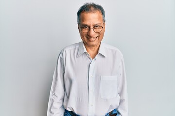 Canvas Print - Middle age indian man wearing casual clothes and glasses with a happy and cool smile on face. lucky person.