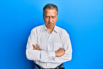 Sticker - Middle age indian man with arms crossed gesture skeptic and nervous, frowning upset because of problem. negative person.