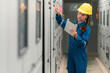 © Chatchawal - Portrait shot half body of young female electrical engineer in electrical control room, action thump up showing the good services working and professional concept.
