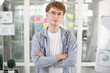 © sofiko14 - Close up of young male creative ofiice worker standing at office with arms crossed