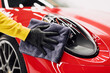 canvas print picture - A man cleaning car with cloth, car detailing (or valeting) concept. Selective focus.