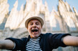 © BullRun - Selfie photo of smiling emotional tourist with open mouth shooting influence travel vlog on retirement, excited male blogger in straw hat feeling happiness and delight during solo vacations