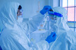 © ake - Asian Medical Scientists wearing PPE protective suit working in laboratory