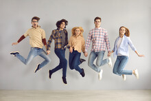 Full-length Studio Portrait Of Enthusiastic Caucasian European Teenager Jumping High Rejoicing Start Of Holidays, End Of Academic Year Or Quarantine, Getting Education Grant Or Admission To University