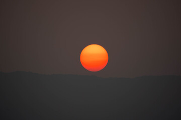 Wall Mural - sunset on sky dark background, big sun golden color on dusk twilight evening wallpaper, beautiful ab