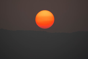 Wall Mural - sunset on sky dark background, big sun golden color on dusk twilight evening wallpaper, beautiful ab