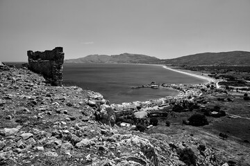 Canvas Print - Ruins of a medieval fortress and the sea coast with the port and town on the island of Rhodes