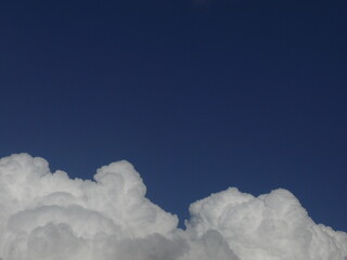 Fluffy white clouds against a blue sky
