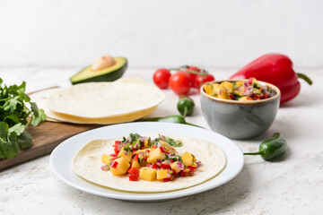 Wall Mural - Composition with fresh mango salsa and tortillas on light background