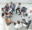 © ASDF - team of young employees sitting in a circle in the conference room .