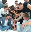 © ASDF - in full growth. a group of young men making a tower of fists